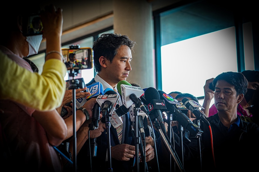 A man stands at a press conference