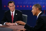 Barack Obama speaks and Mitt Romney listens during third debate