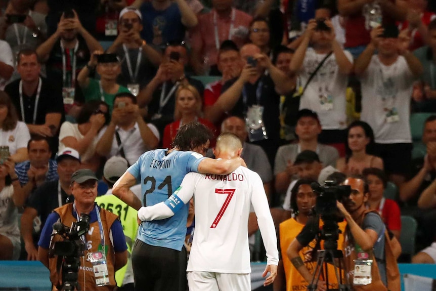 Ronaldo helps Cavani off the field arm in arm as fans take photos