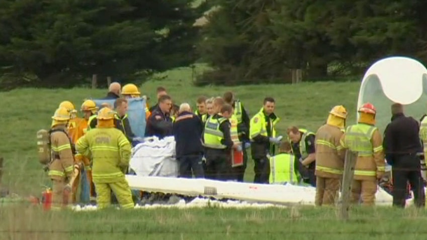 Emergency officials move one of the injured to a waiting air ambulance.