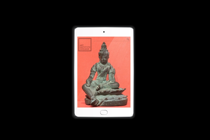 A white tablet shows photo of a seated bronze Bodhisattva Avalokiteshvara sculpture on red paper background 
