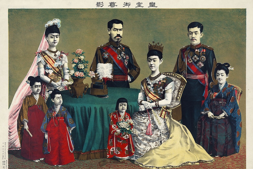 An illustration of the Imperial family of Japan shows men, women and children seated around a green table in imperial regalia.