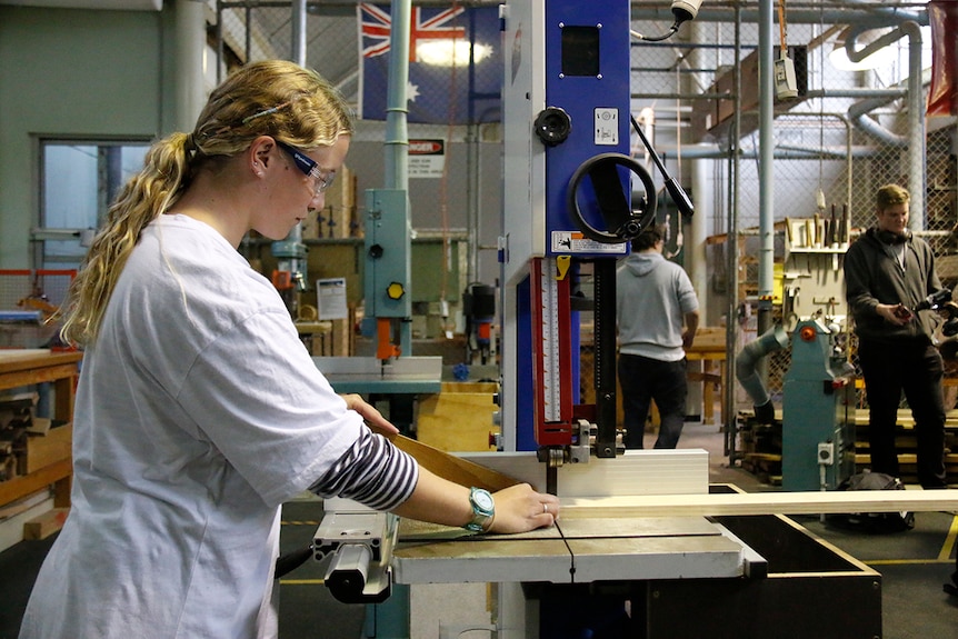 Woodwork student Caitlin Nichols using a band saw at Lake Ginninderra College, Canberra.