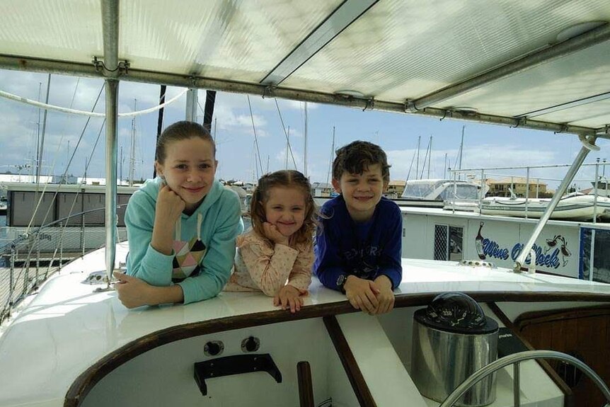 Chanelle, Ciel and Dylan Willems relax on the boat.