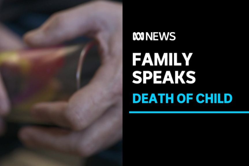 Family Speaks, Death of Child: Close up of hands holding a cylindrical object.