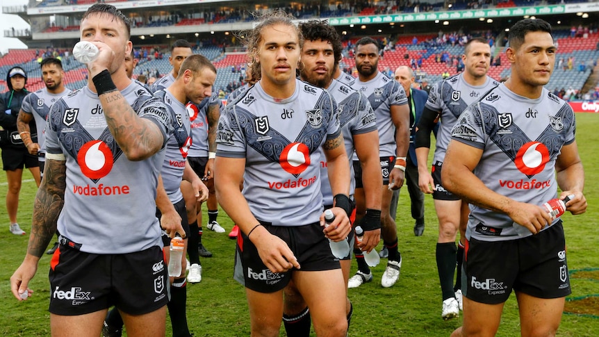 Male Warriors players walk off the field after losing a match to the Knights in Newcastle.