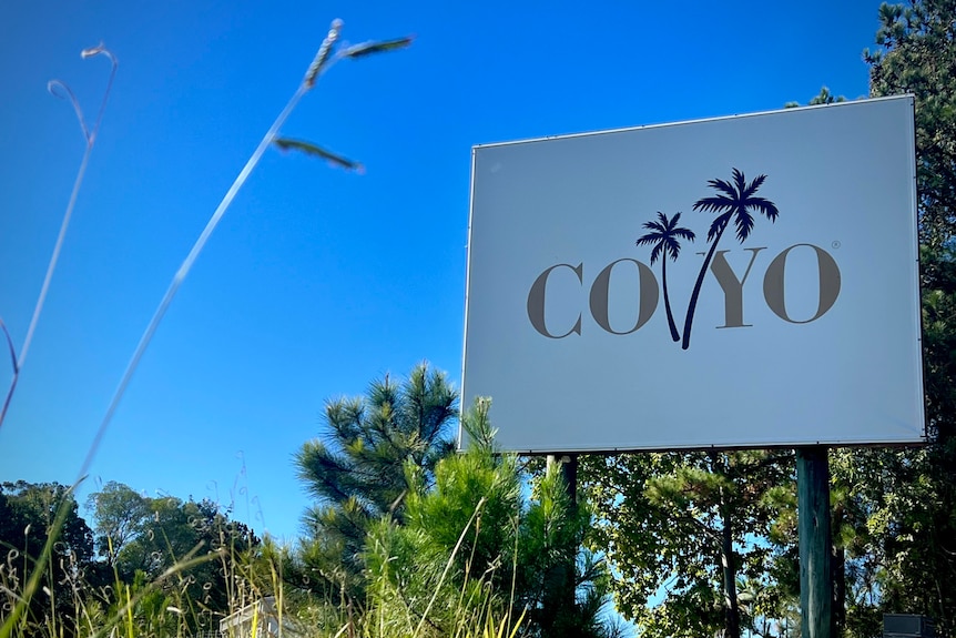 a large sign for the brand CoYo outside its factory on a sunny day