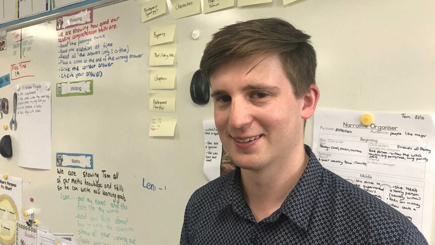 A headshot of teacher Tom Davis in front of a whiteboard in his classroom at Montmorency South Public school in Melbourne.