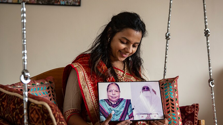 Nimita Bagadia holding pictures of her grandmother