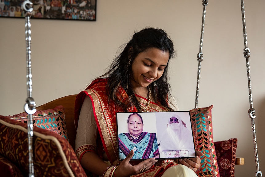 Nimita Bagadia holding pictures of her grandmother