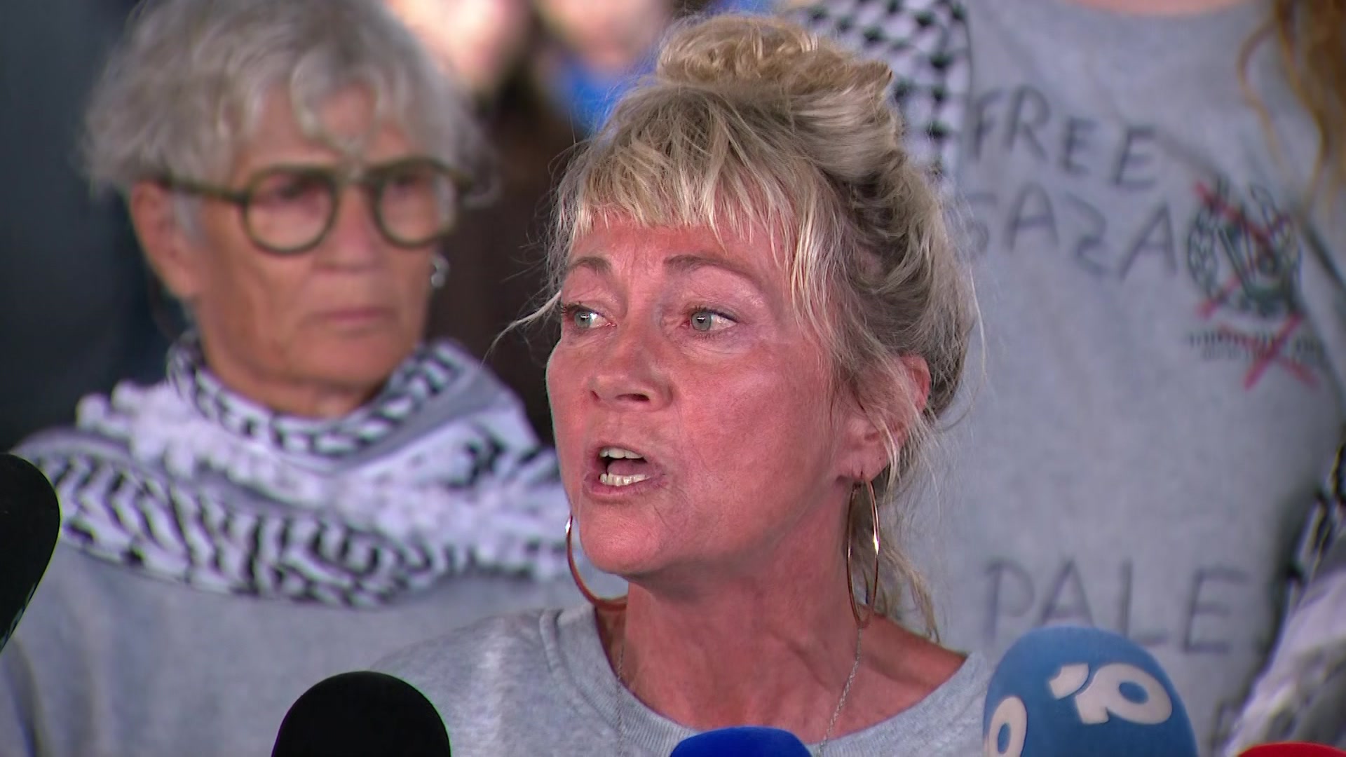 A woman standing at a microphone.