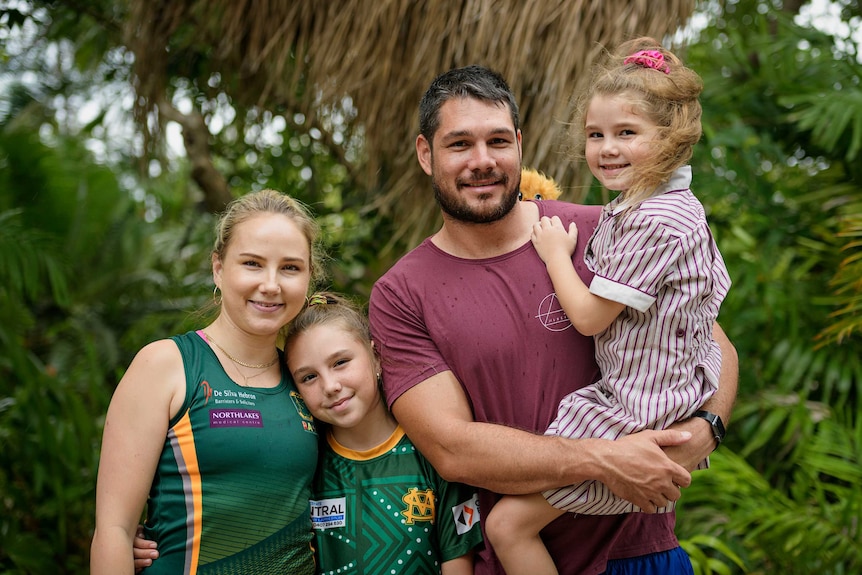 Lennair and Aidan Hill smile to the camera with daughters Lakhyah and Natayah.