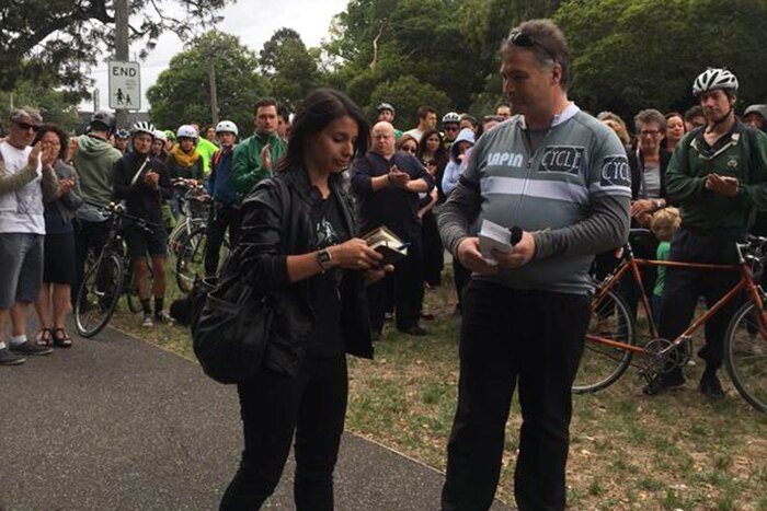 Killed cyclist Alberto Paulon's fiancee Cristina Canedda speaks to a crowd of commemorative riders on Sydney Rd, in Brunswick.