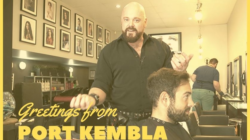A hairdresser and his client in the shop with Greetings from Port Kembla