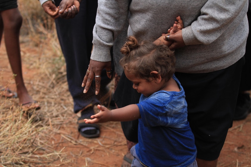 A young girl hold her arm out
