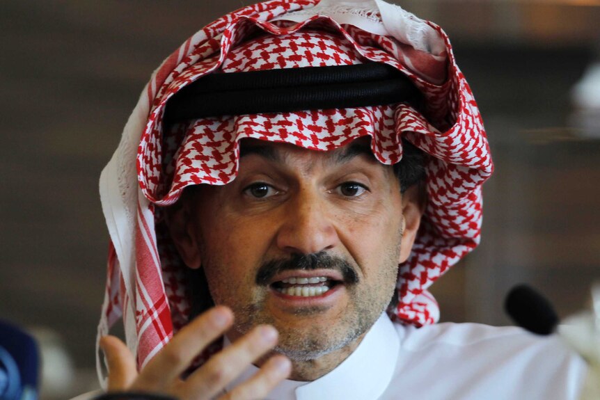 Saudi Arabian Prince Alwaleed bin Talal looks directly into the camera as he speaks at a news conference.