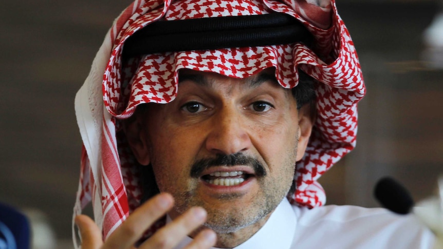 Saudi Arabian Prince Alwaleed bin Talal looks directly into the camera as he speaks at a news conference.