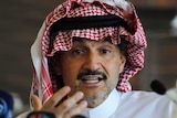 Saudi Arabian Prince Alwaleed bin Talal looks directly into the camera as he speaks at a news conference.