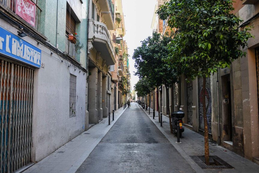 normally bustling street with all the shutters down and shops closed in Spain