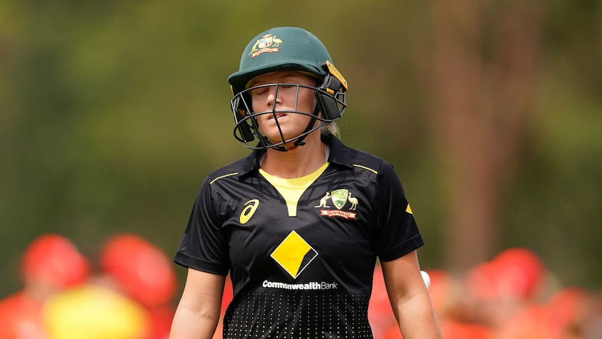 Alyssa Healy walks with her eyes closed and her shoulders slumped