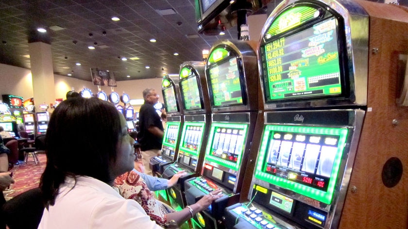 A woman plays on a bingo machine