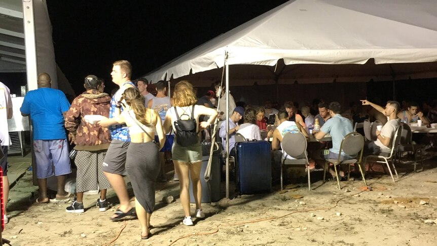Attendees eat dinner at the site of the cancelled Fyre Festival in the Bahamas.