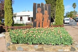 The Nannup townsite. A statue with flowers in front.