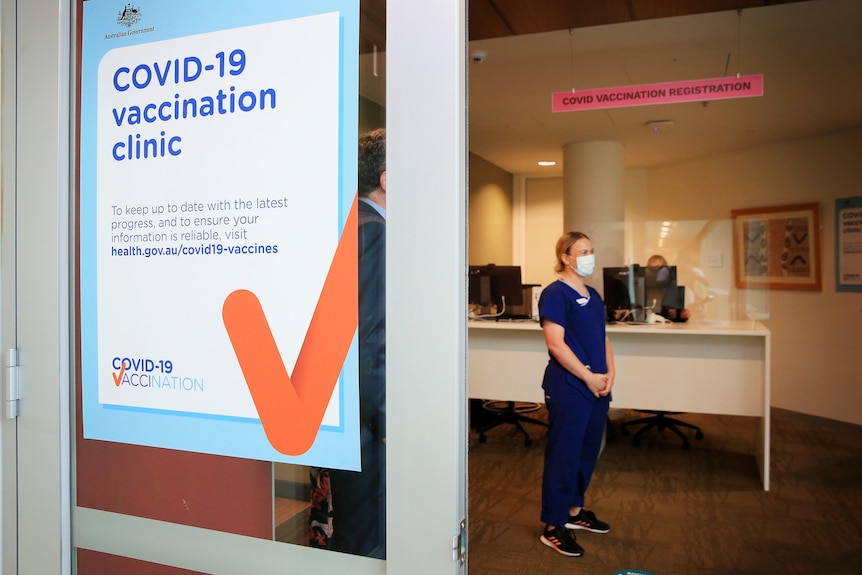 A nurse stands waiting in an empty COVID-19 clinic.