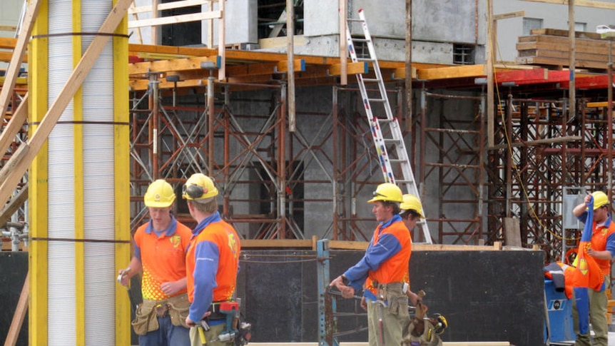 Builders work on a construction site in Hobart.