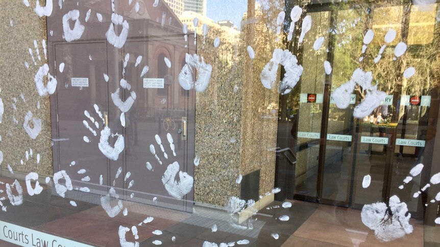 Handprints on law court windows