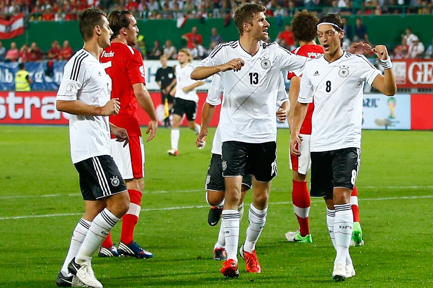 Ozil reacts after scoring against Austria