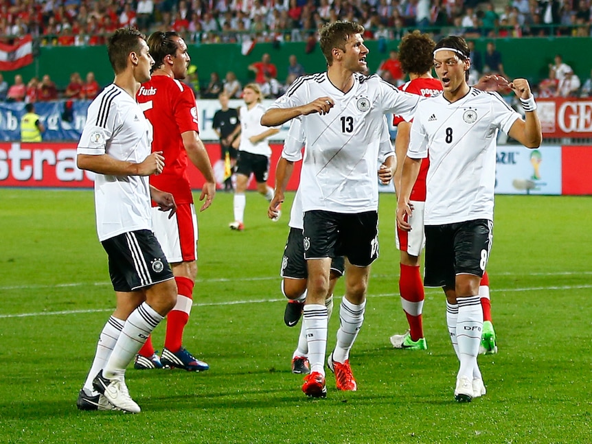 Ozil reacts after scoring against Austria