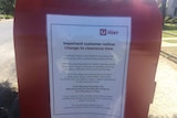 A notice on a post box announces a change to clearing times.