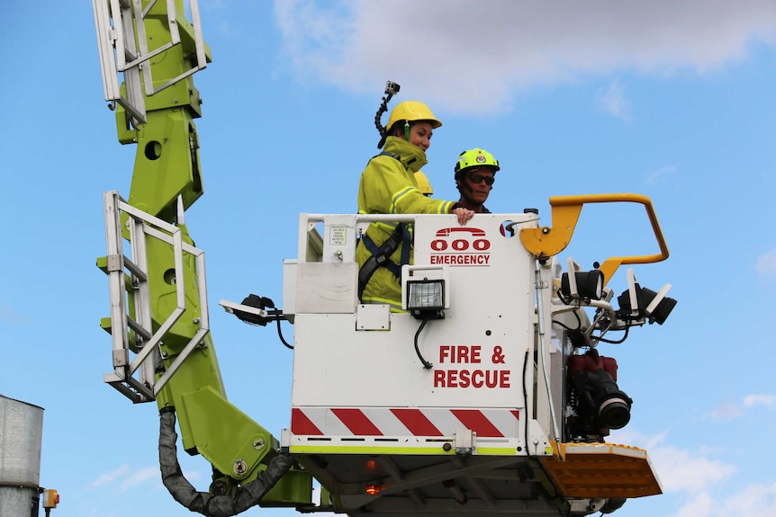 ABC News Canberra journalist Alkira Reinfrank in an aerial appliance which extends up to 44 metres in the air