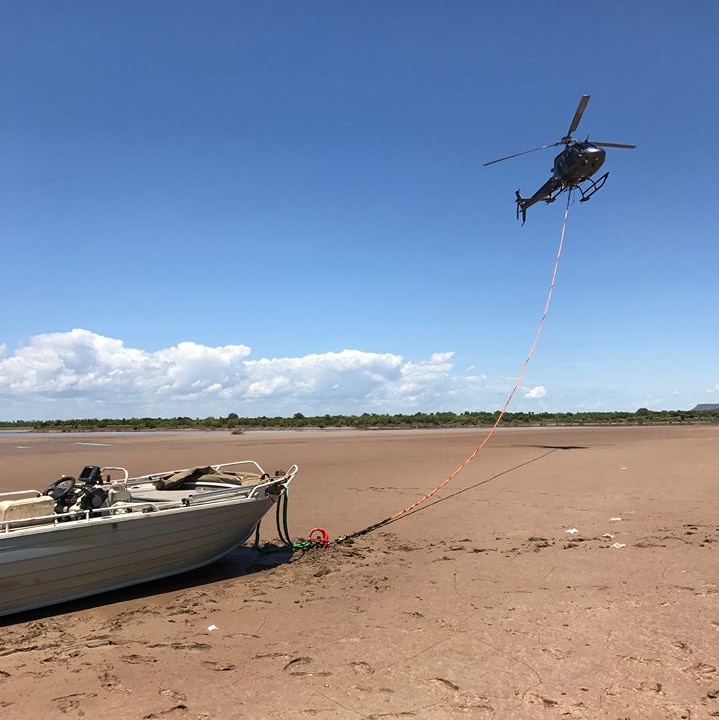 helicopter towing a boat to safety