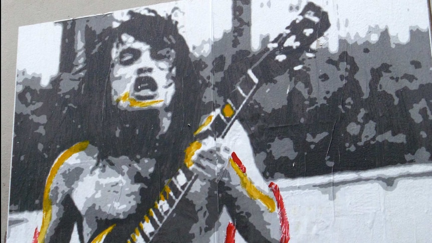 Graffiti of Bon Scott, from the band ACDC, playing guitar in Flinders Lane, Melbourne.