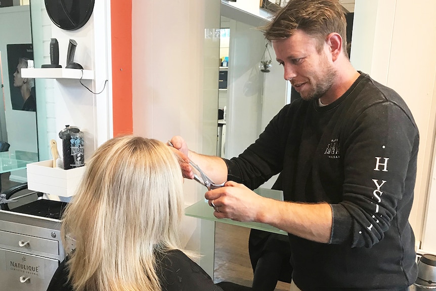 Kieran Harrison, of Koko Hair Design in Howrah, with client.