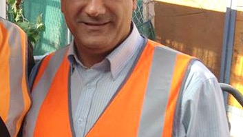 Con Hindi in a construction hard hat and high-vis vest.