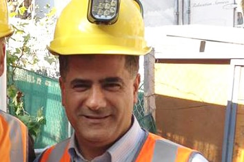 Con Hindi in a construction hard hat and high-vis vest.