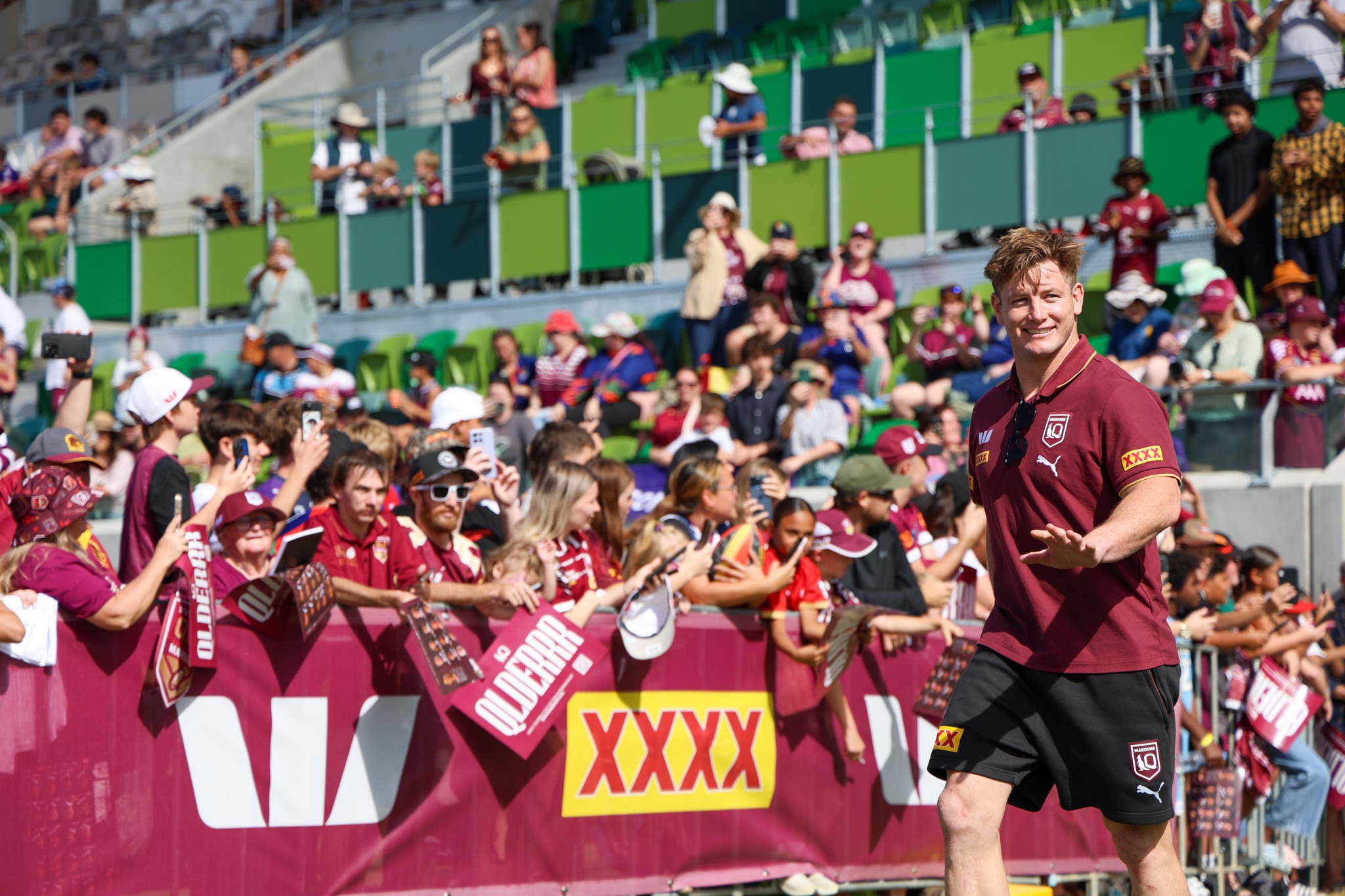A football player walking onto a field in front of home fans