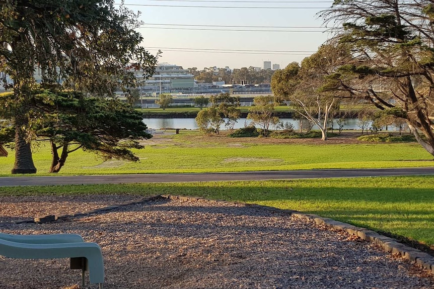 A slide is shown at a playground, in front of lawns on the Maribyrnong River.