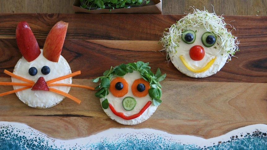 Rice cakes with toppings arranged to make a face