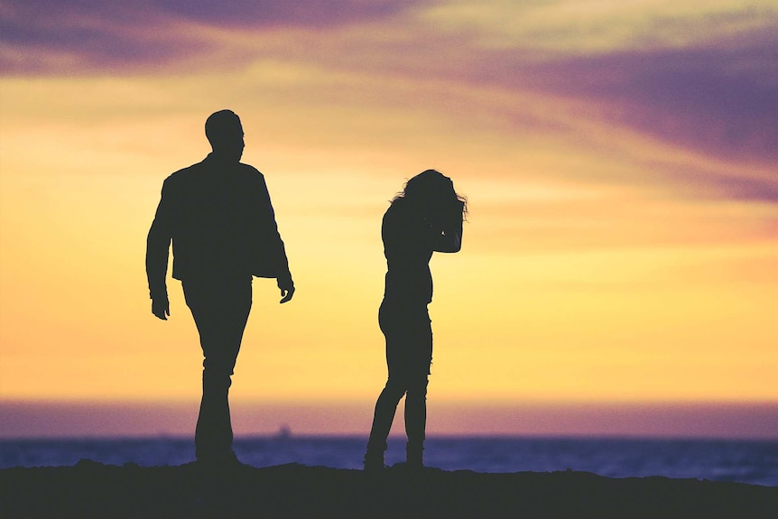 Man and a woman silhouetted against a sunrise to depict a story on how to spot domestic violence and what to do.