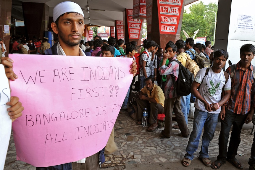 A student belonging to the Muslim community holds a placard at a railway station in Bangalore.