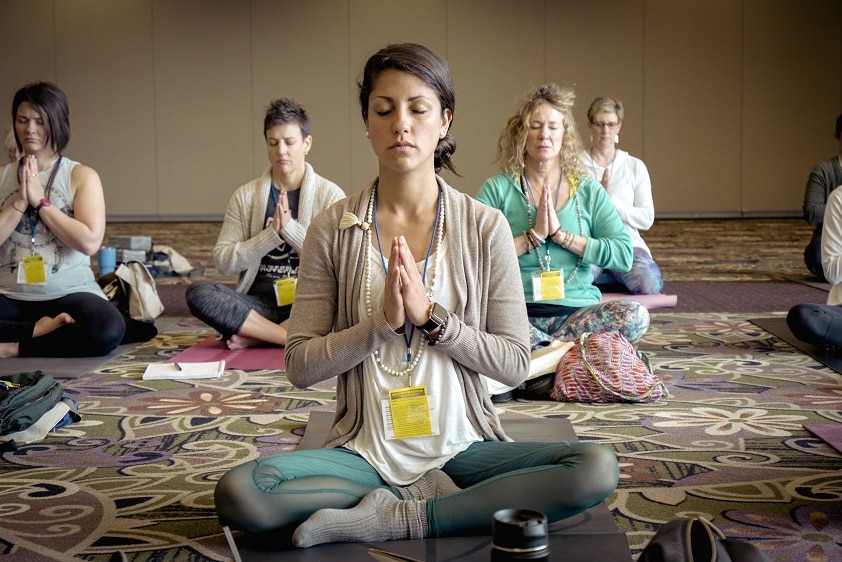 A group of women meditating in a room