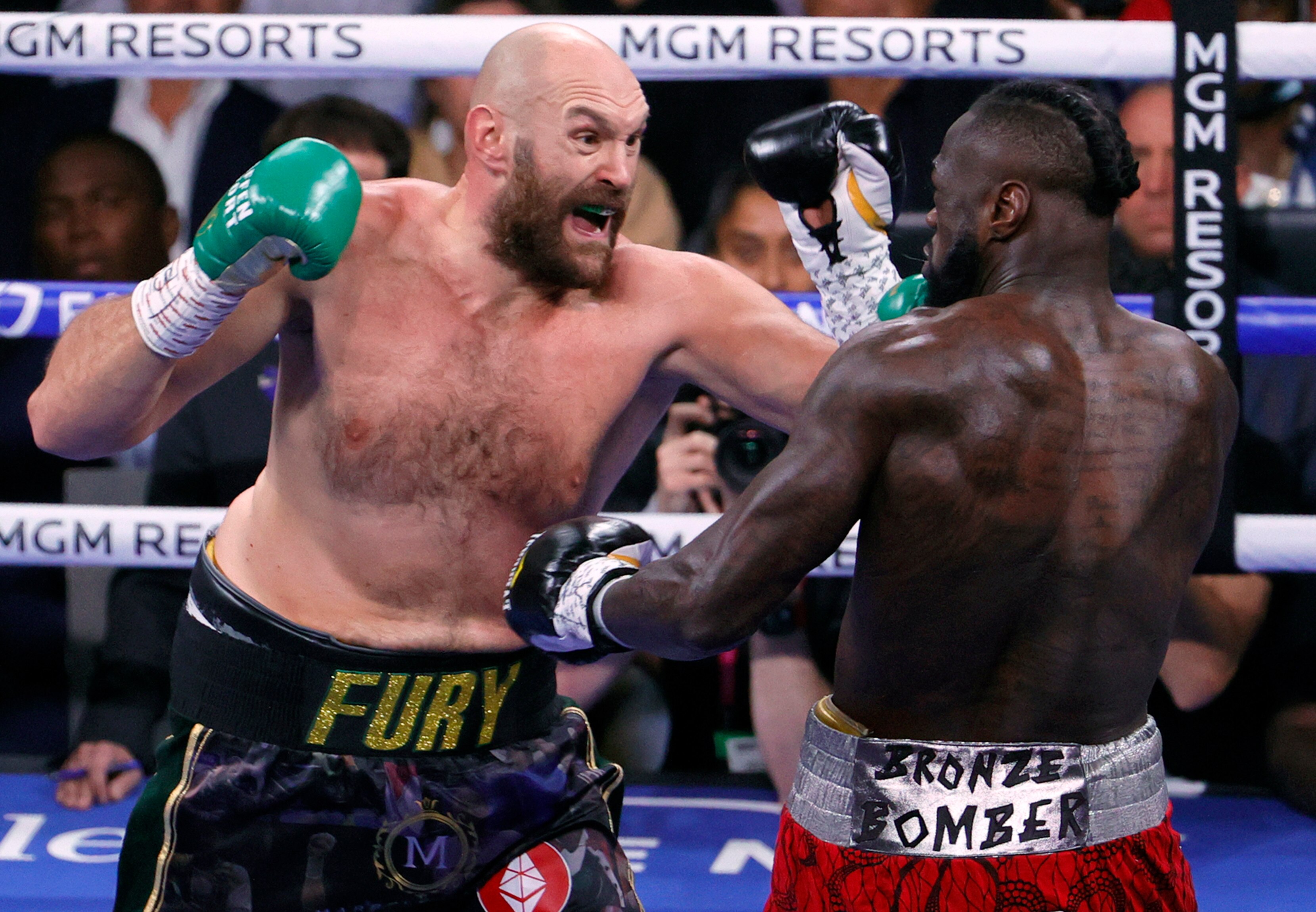 Tyson Fury opens his mouth as he punches Deontay Wilder