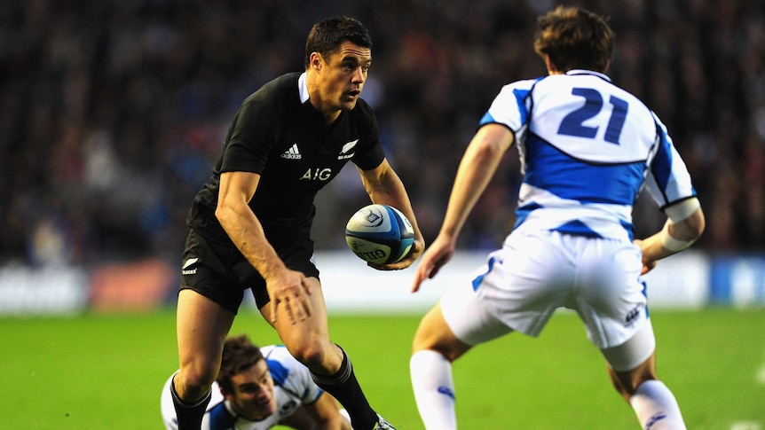 Maestro's night ... New Zealand fly half Dan Carter weaves through the Scottish defence.