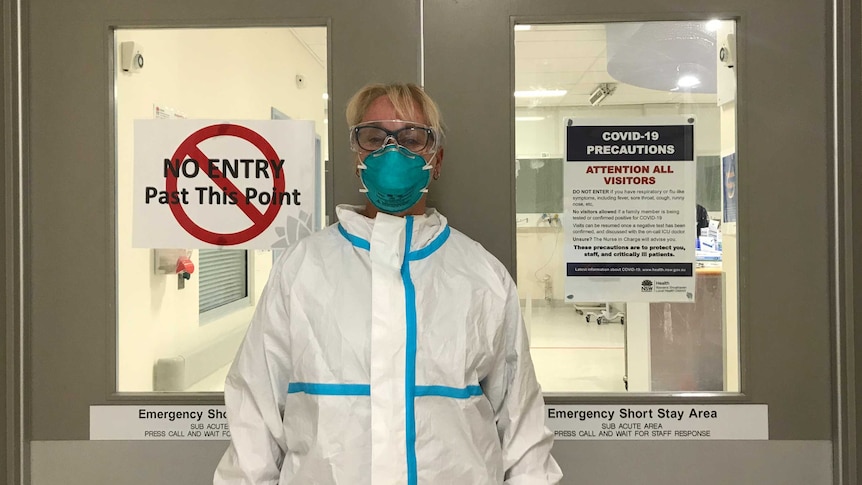 A nurse wears full PPE at work