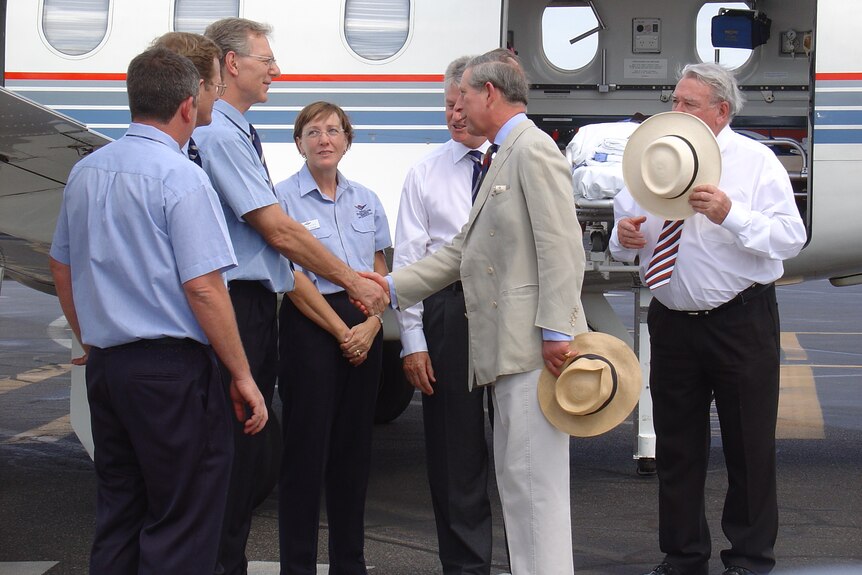 Prince Charles shakes hands with RFDS staff at Alice Springs airport in 2005.