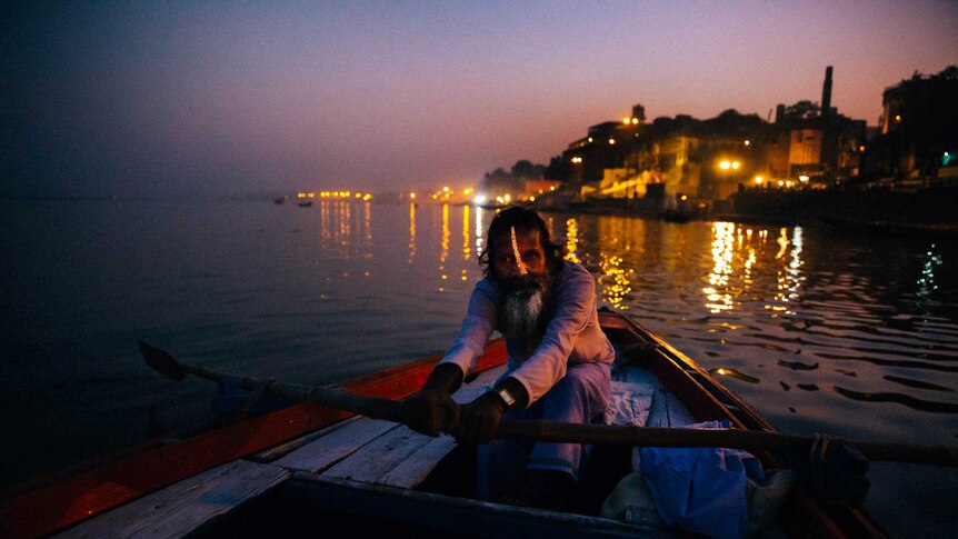 A Varanasi boatman paddles along the Ganges river